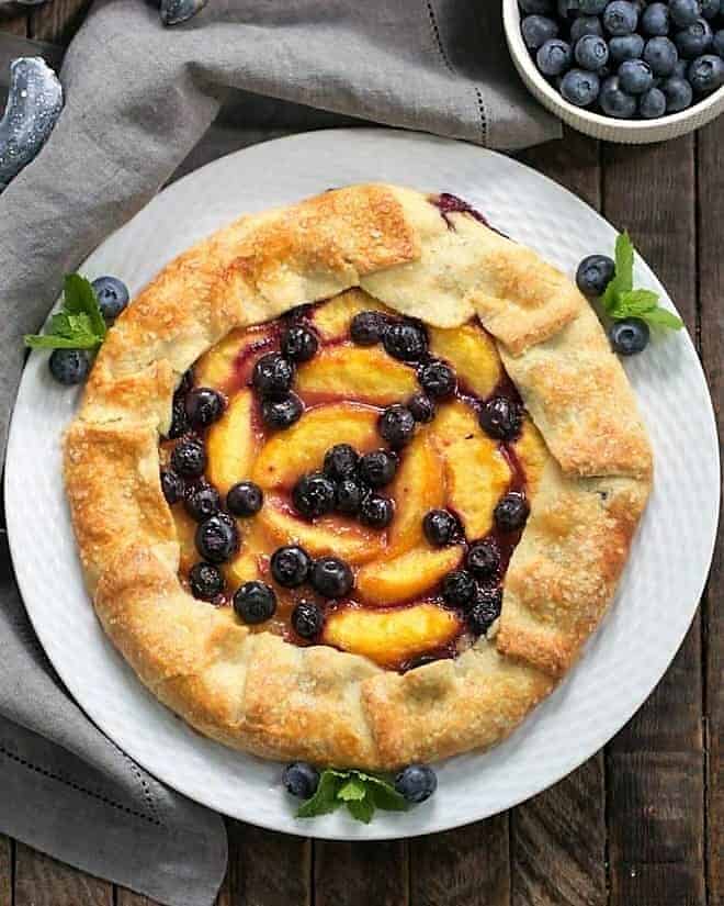 Overhead view of Peach Blueberry Galette on a white serving plate