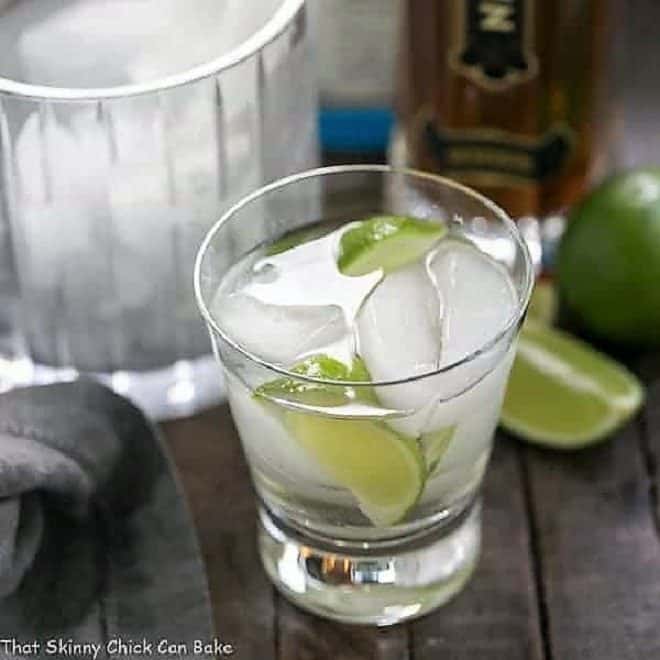 St. Germain Gin and Tonic Cocktail in a short glass with lime wedges