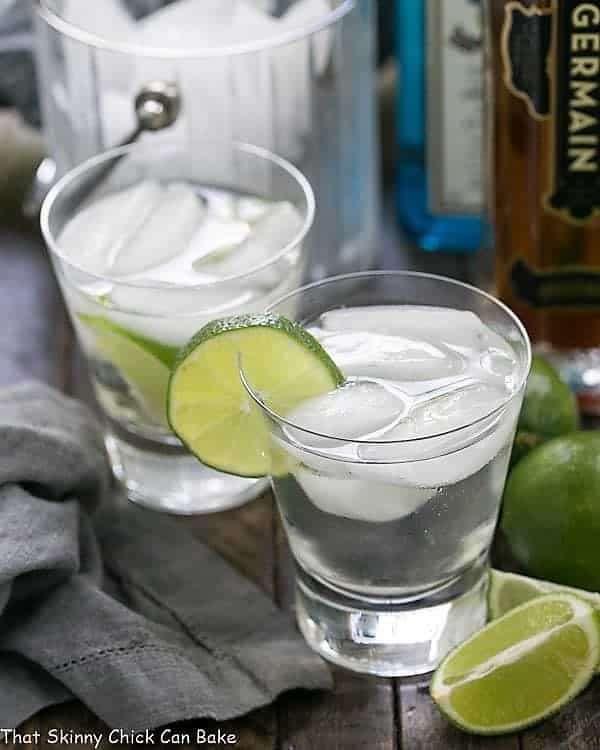 Two St. Germain Gin and Tonic Cocktails in glasses with a lime garnish.