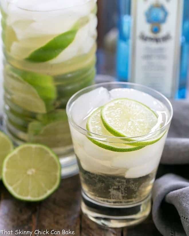 St. Germain Gin and Tonic Cocktail in a short glass with ice cubes and lime slices.