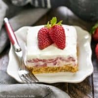 Strawberry Cheesecake Lush Dessert slice on a white dessert plate