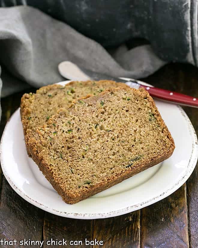 Zucchini Bread slices on a round white ceramic plate.