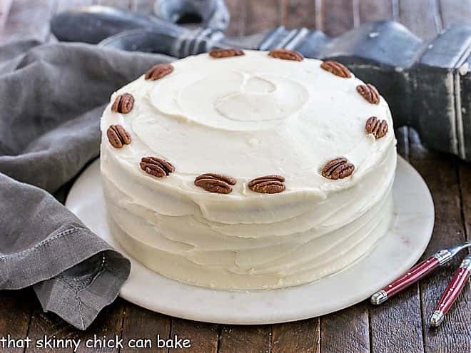 Hummingbird Cake Recipe with coconute on a serving platter.