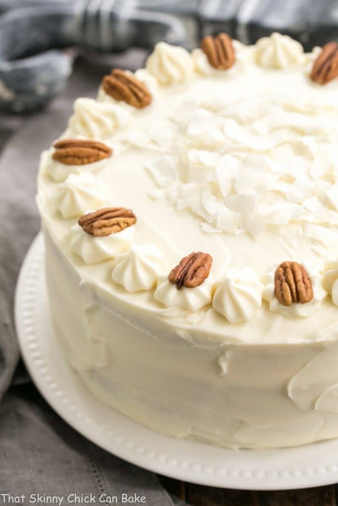 Classic Hummingbird Cake with Coconut on a white serving plate