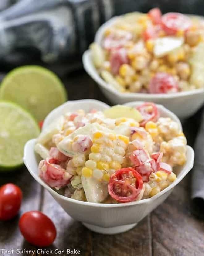Spicy Mexican Corn Salad in two white tulip bowls.