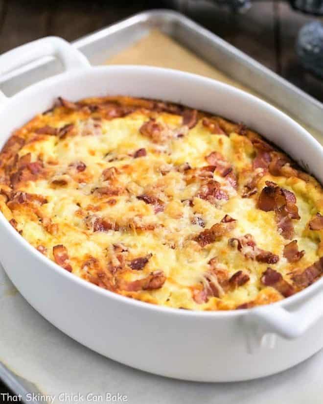 Cauliflower bacon gratin in a white baking dish on a sheet pan