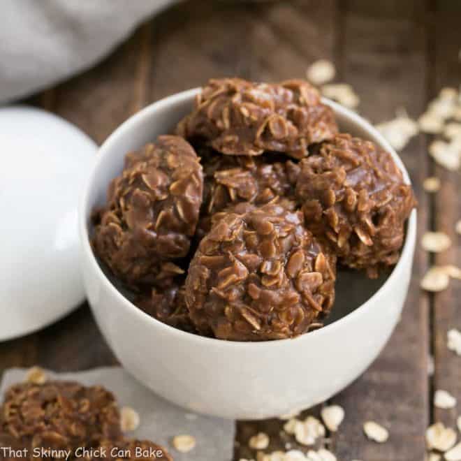 Classic Chocolate Peanut Butter No Bake Cookies in a white ceramic bowl with a lid in the background