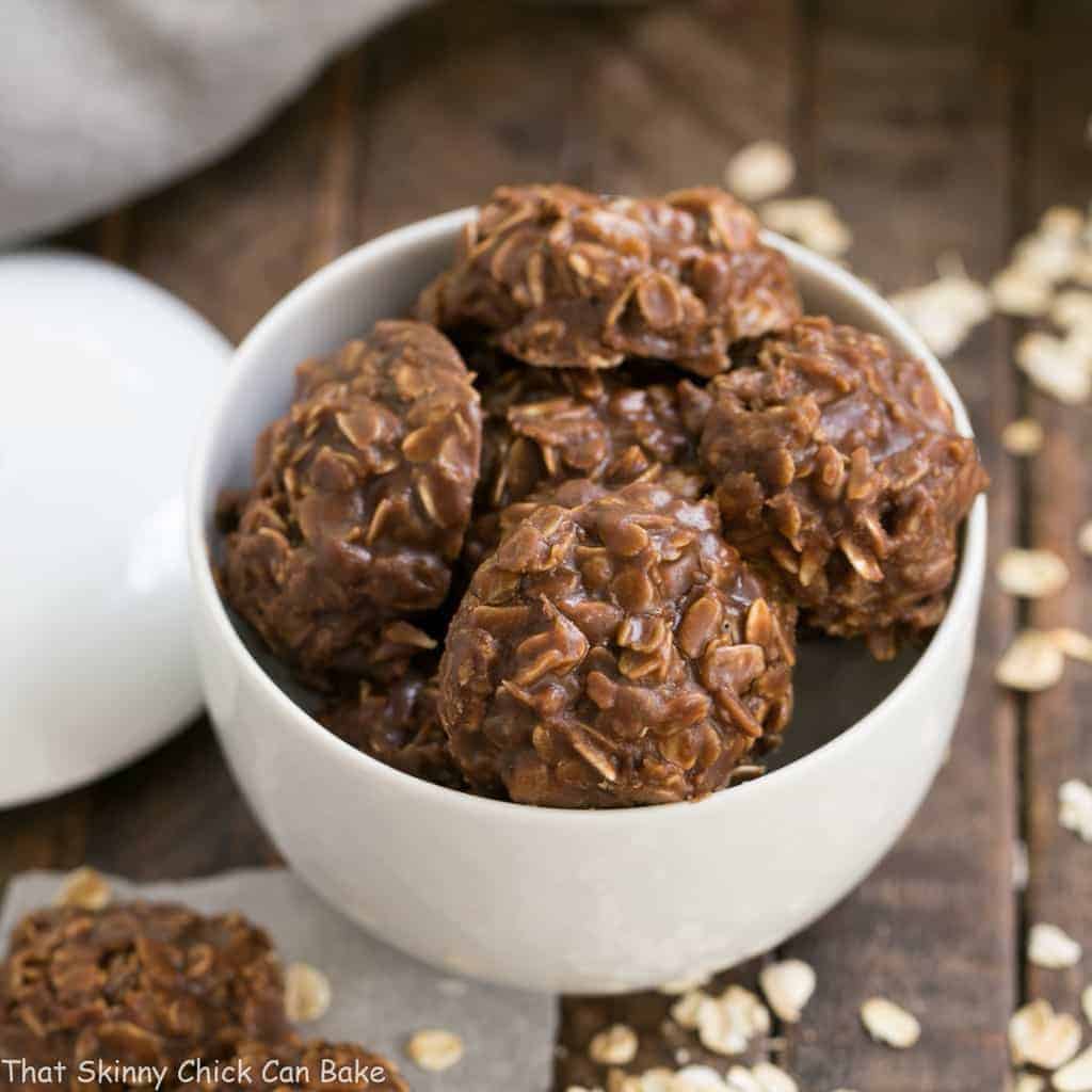 Classic Chocolate Peanut Butter No Bake Cookies in a white ceramic bowl with a lid in the background.