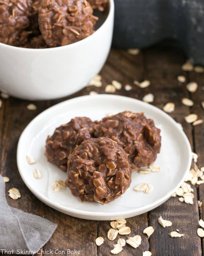 Classic Chocolate Peanut Butter No Bake Cookies on a round white plate with a bowl of cookies in the background