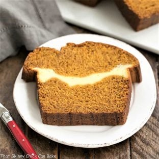 Cream Cheese Filled pumpkin bread slice on a round white plate