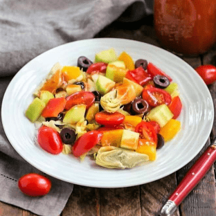 Easy Honey French Salad Dressing on a green salad on a white ceramic plate