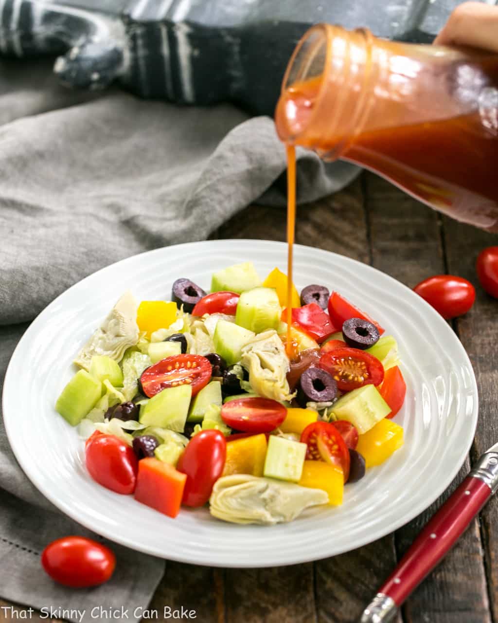 Easy Honey French Salad Dressing poured over a green salad.