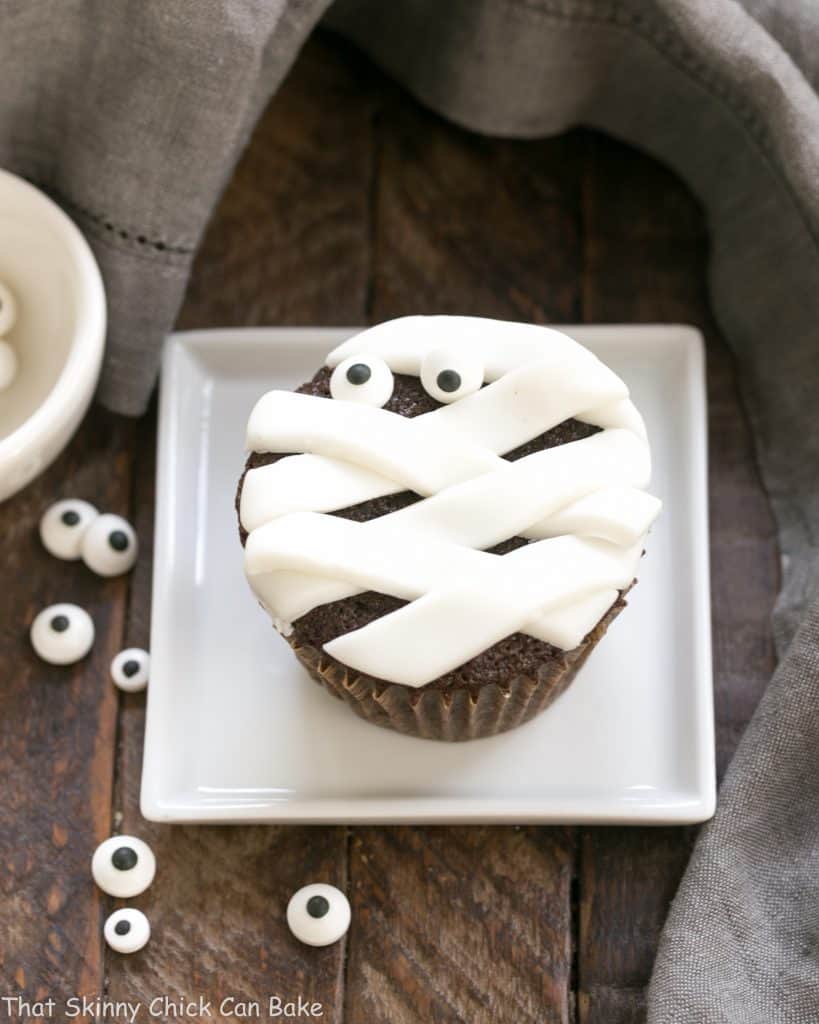 EASY Chocolate Mummy Cupcakes on a square white plate