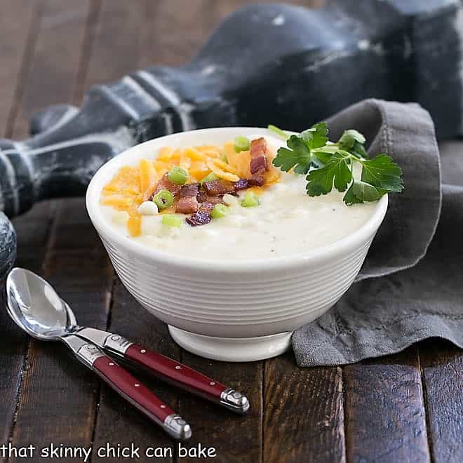 Easy Potato Soup in a white bowl with two soup spoons