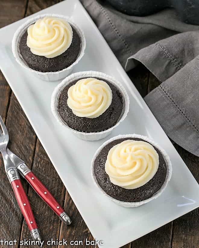 Frosted Black Bottom Cupcakes on a white tray.