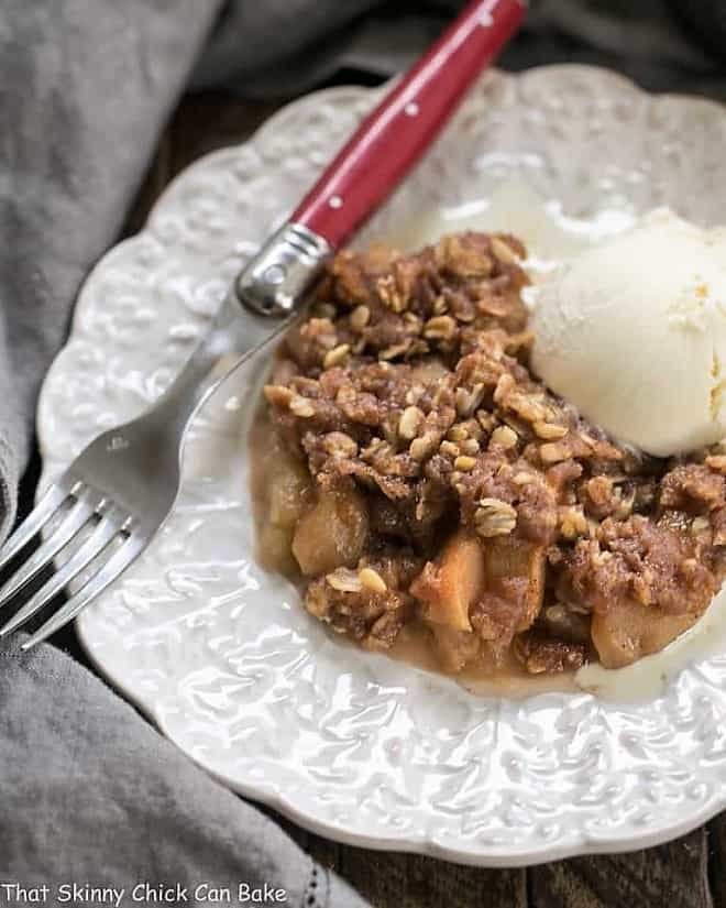 Easy Slow Cooker Apple Crisp on a decorative white plate.