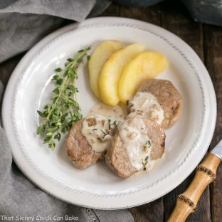 Apple Topped Pork Medallions with Calvados Cream Sauce | A gourmet entree that's easy enough for a weeknight!