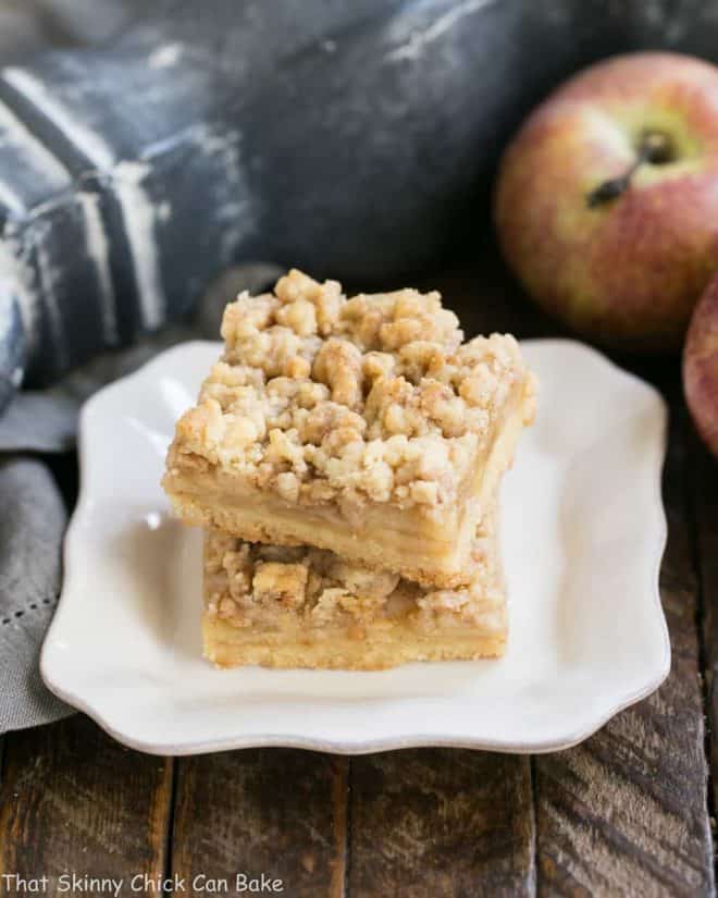 Caramel Apple Pie Toffee Bars - A delectable autumn apple treat! Caramel Apple Pie Toffee Bars stacked on a square white plate