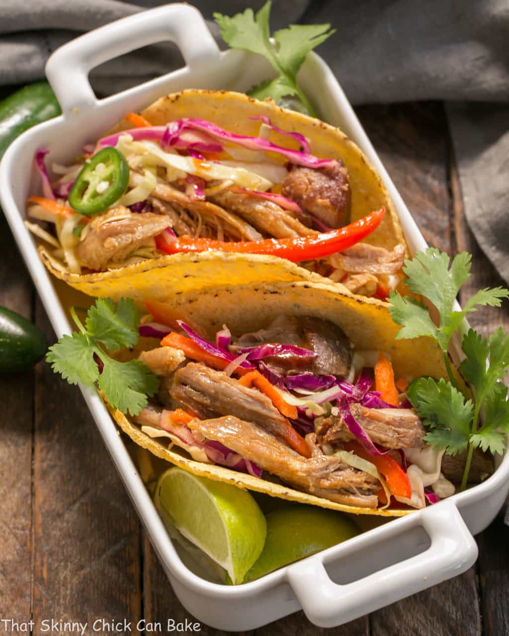 Slow Cooker Asian Pork Tacos with Cabbage Slaw in a white casserole dish.