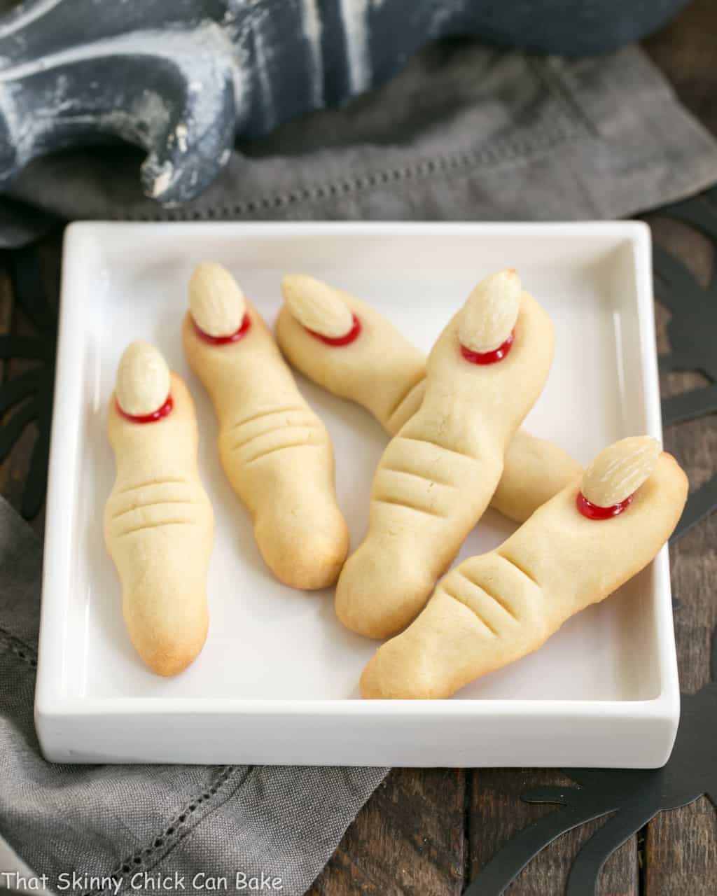 Witches Fingers Cookies fanned out on a rimmed white square plate.