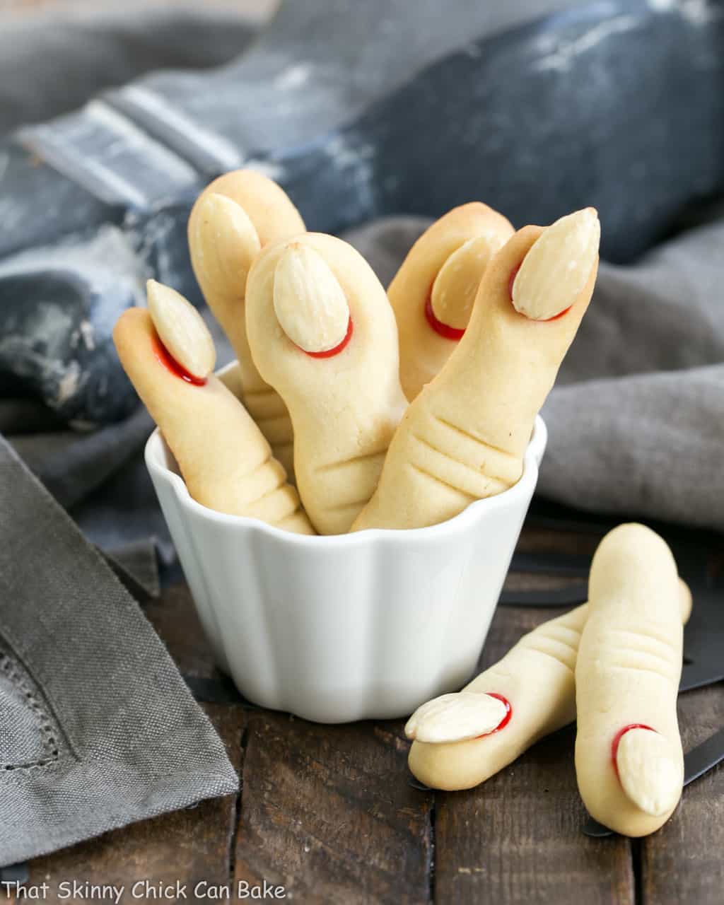 Witches Fingers Cookies standing upright in a white ramekin.