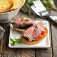 Beef Crostini with Blue Cheese Spread | Baguette toasts smeared with a blue cheese spread and topped with peppers or tomatoes and rare grilled beef!