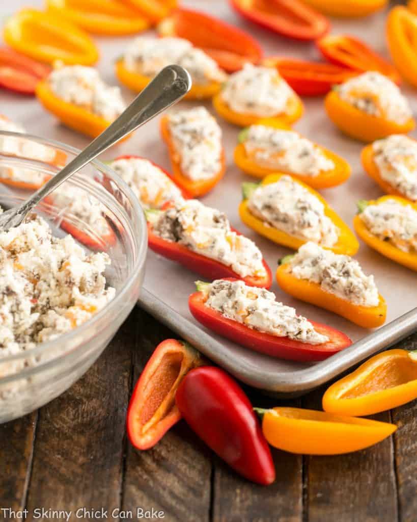 Unbaked Cream Cheese Stuffed Mini Peppers with Sausage on a baking sheet