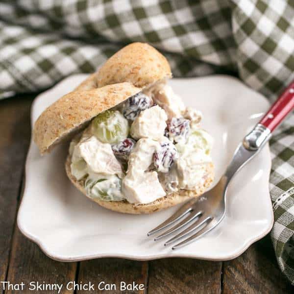 Curried Turkey Salad Sandwich on a whole wheat bun on a square white plate