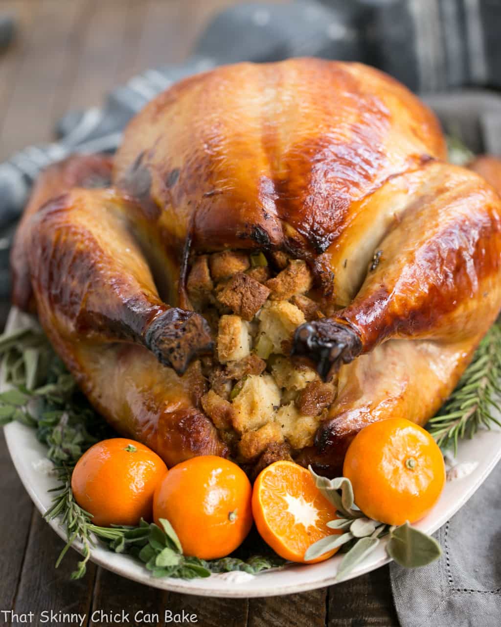 Honey Brined Turkey Recipe view of stuffing end with herbs and oranges.