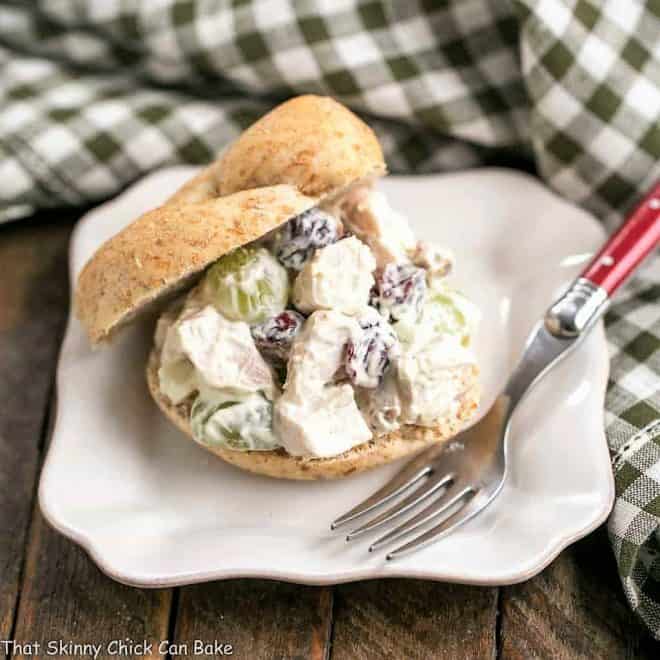 Curried Turkey Salad Sandwich on a white square plate with a fork