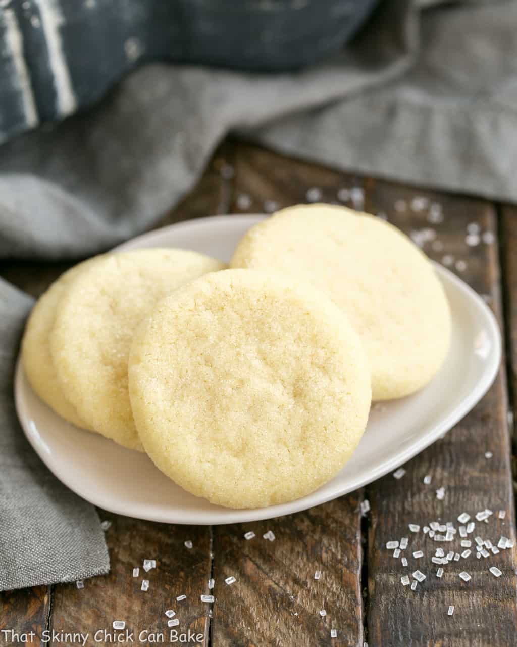 3 Old-Fashioned Amish Sugar Cookies on a tear shaped white plate.