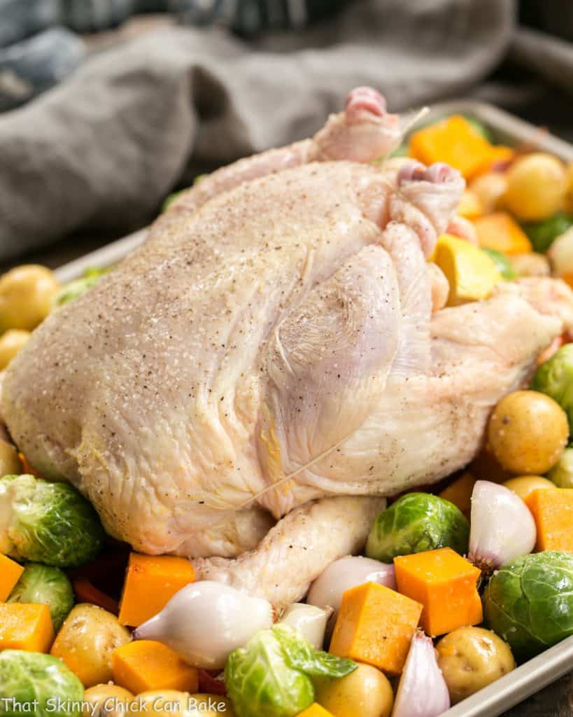 Chicken with Roasted Fall Vegetables on a sheet pan before cooking