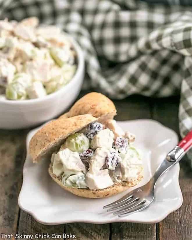 Curried Turkey Salad Sandwich on a square white plate with a green plaid napkin