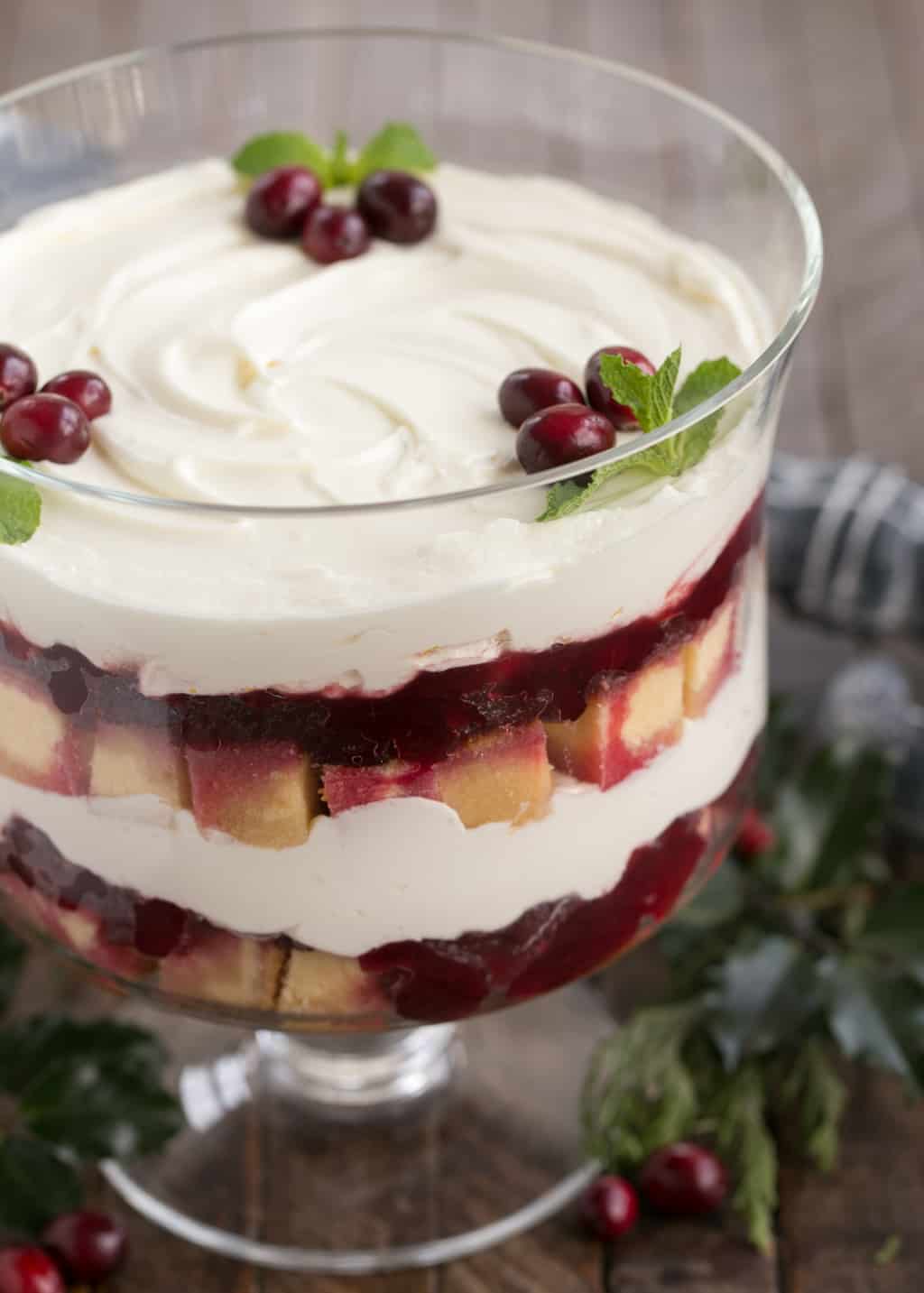 an easy trifle recipe layered into a clear glass trifle bowl.