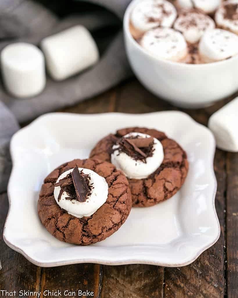 Marshmallow Topped Hot Cocoa Cookies or Hot Chocolate Cookies on a small white plate with a cup of hot cocoa.