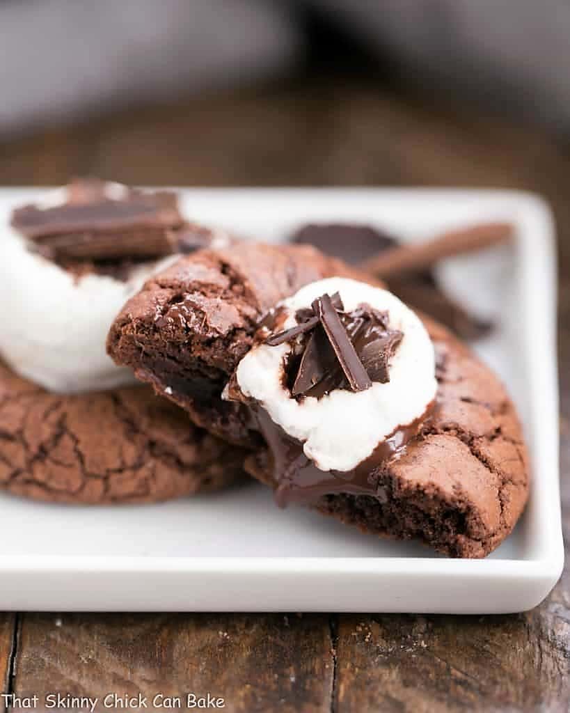 Marshmallow Topped Hot Cocoa Cookies or Hot Chocolate Cookies on a square white plate with one cookie broken open.