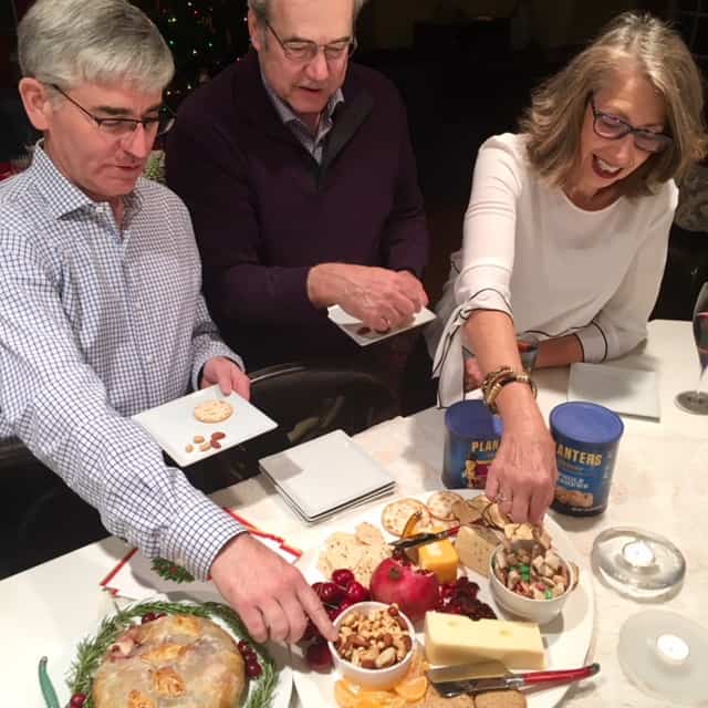 party guests snacking on party foods like snack mix and dips