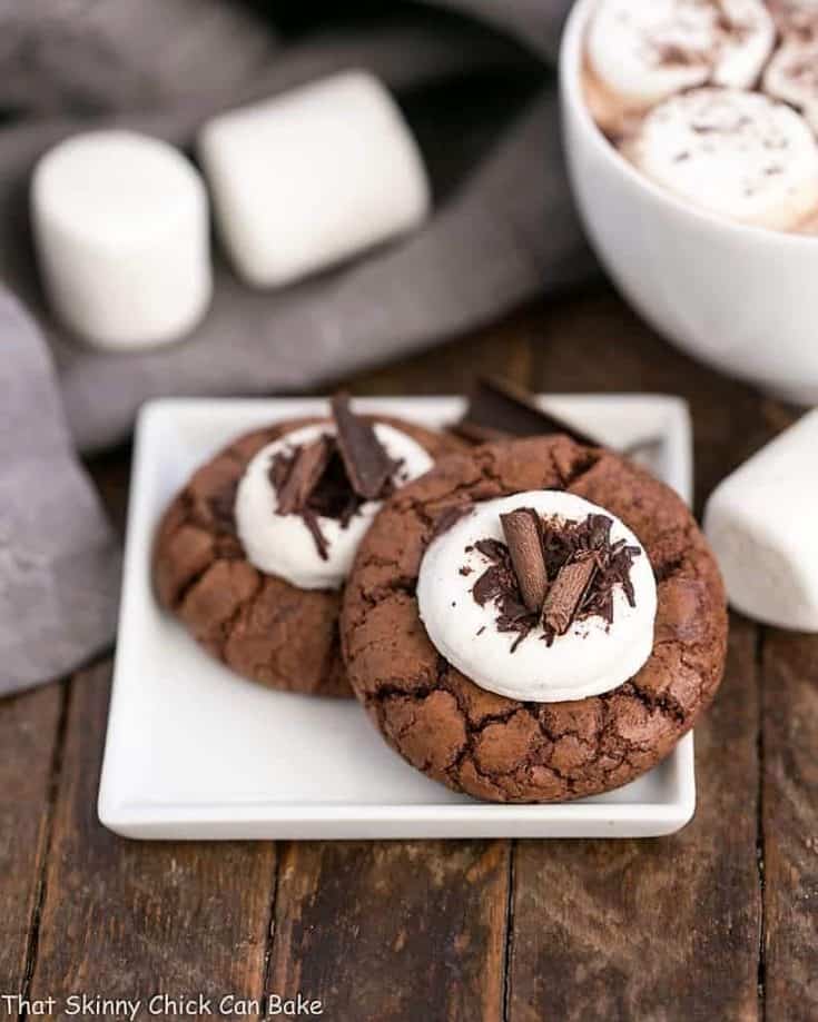 Marshmallow Topped Hot Cocoa Cookies or Hot Chocolate Cookies on a small whit plate with marshmallows and mug of hot chocolate