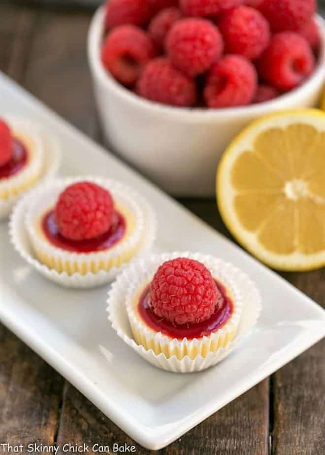 Raspberry Topped Mini Cheesecakes on a white platter