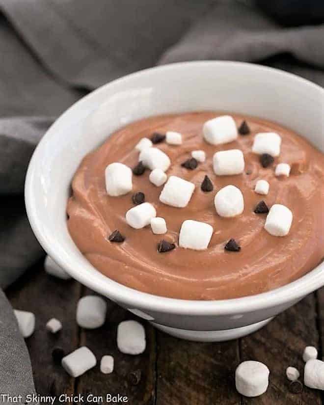Easy S'mores Dessert Dip in a white ceramic bowl topped with marshmallows and chocolate chips.
