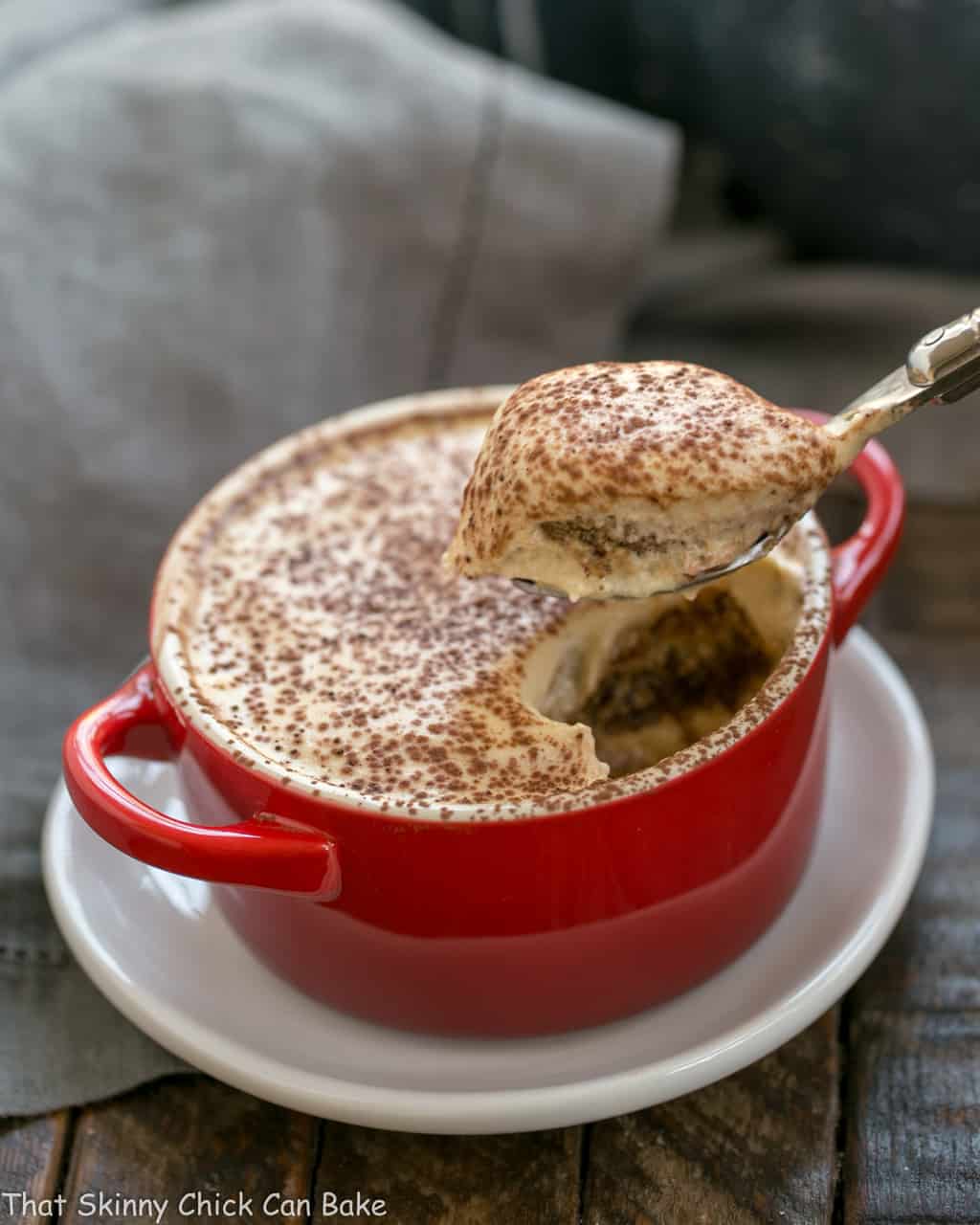 Kahlua Tiramisu for Two in a red cocotte with a spoon.