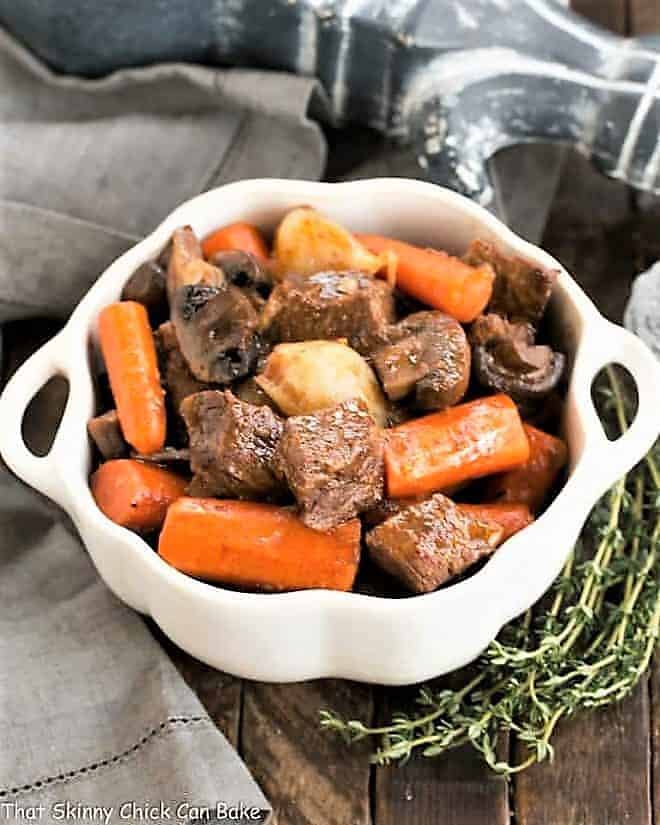 Slow cooker beef stew with mushrooms in a casserole dish