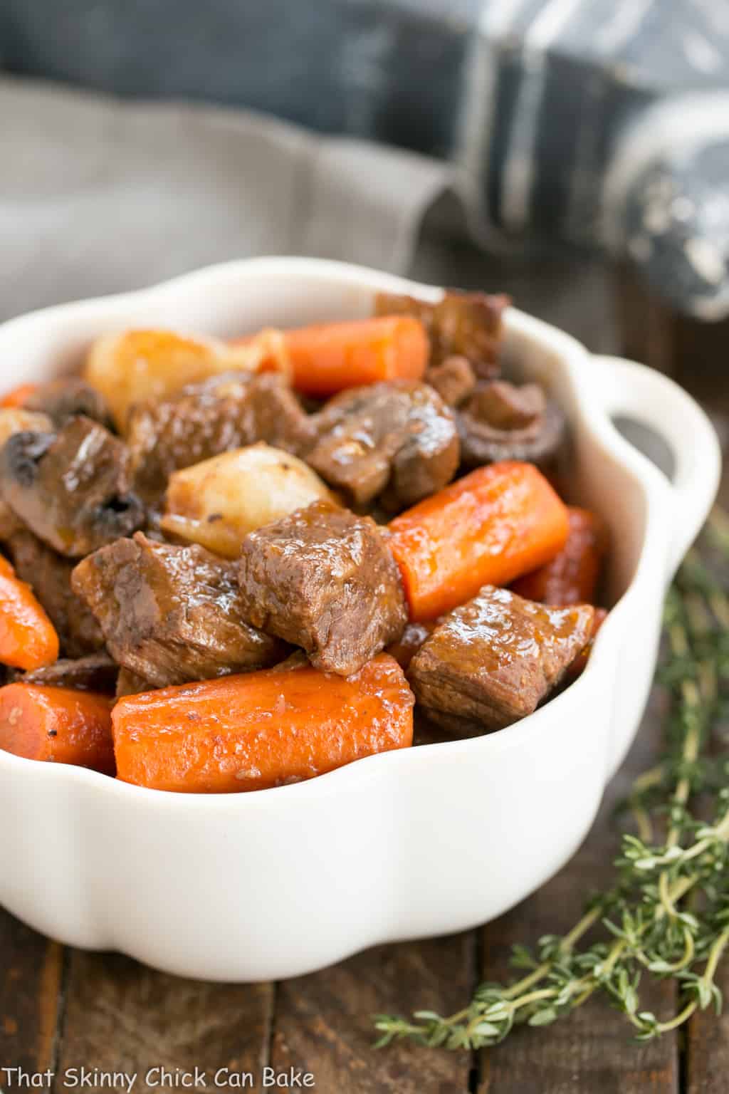 Slow Cooker Beef Stew with Mushrooms in a white bowl.