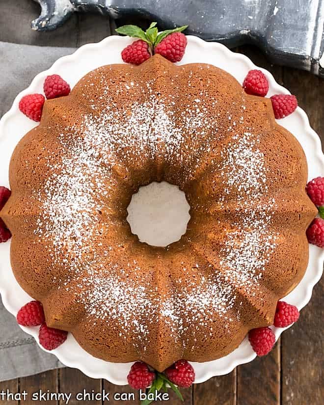 Overhead view of white chocolate pound cake on a white cake stand.