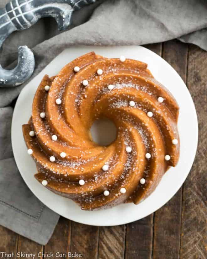 White Chocolate Bundt Cake Flavored with vanilla and a touch of almond, this glazed Bundt cake is a winner! Overhead view of a White Chocolate Bundt Cake on a white serving plate