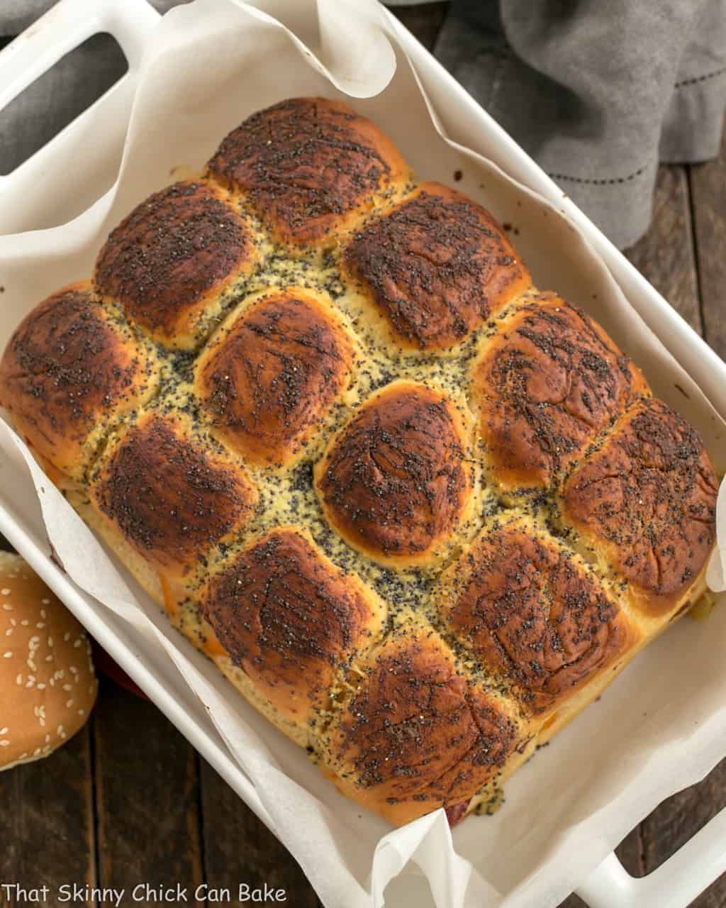 Corned Beef Sliders in a white ceramic baking dish viewed from above.