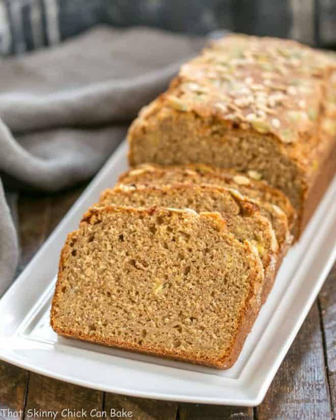 Seed-Topped Whole Wheat Banana Bread slices on a white tray