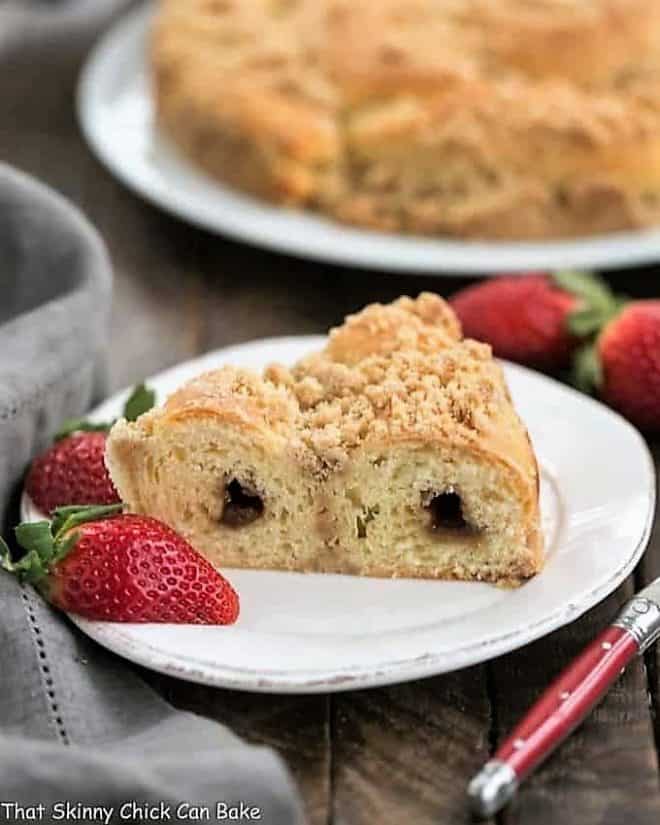 Slice of Streusel Coffee Cake Recipe on a white plate with strawberries