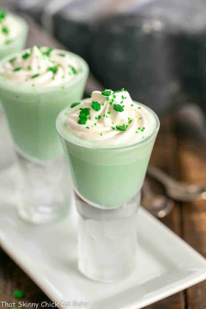  3 Shamrock Shooters with Creme de Menthe on a white tray