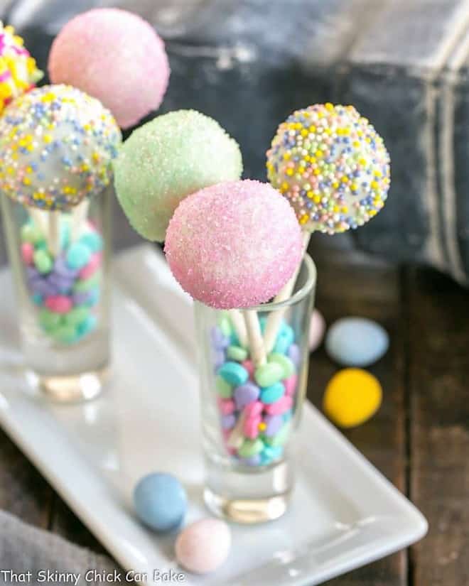 Easter Cake Pops - a festive holiday treat made with just four ingredients Easter Cake Pops in shot glasses on a porcelain tray.